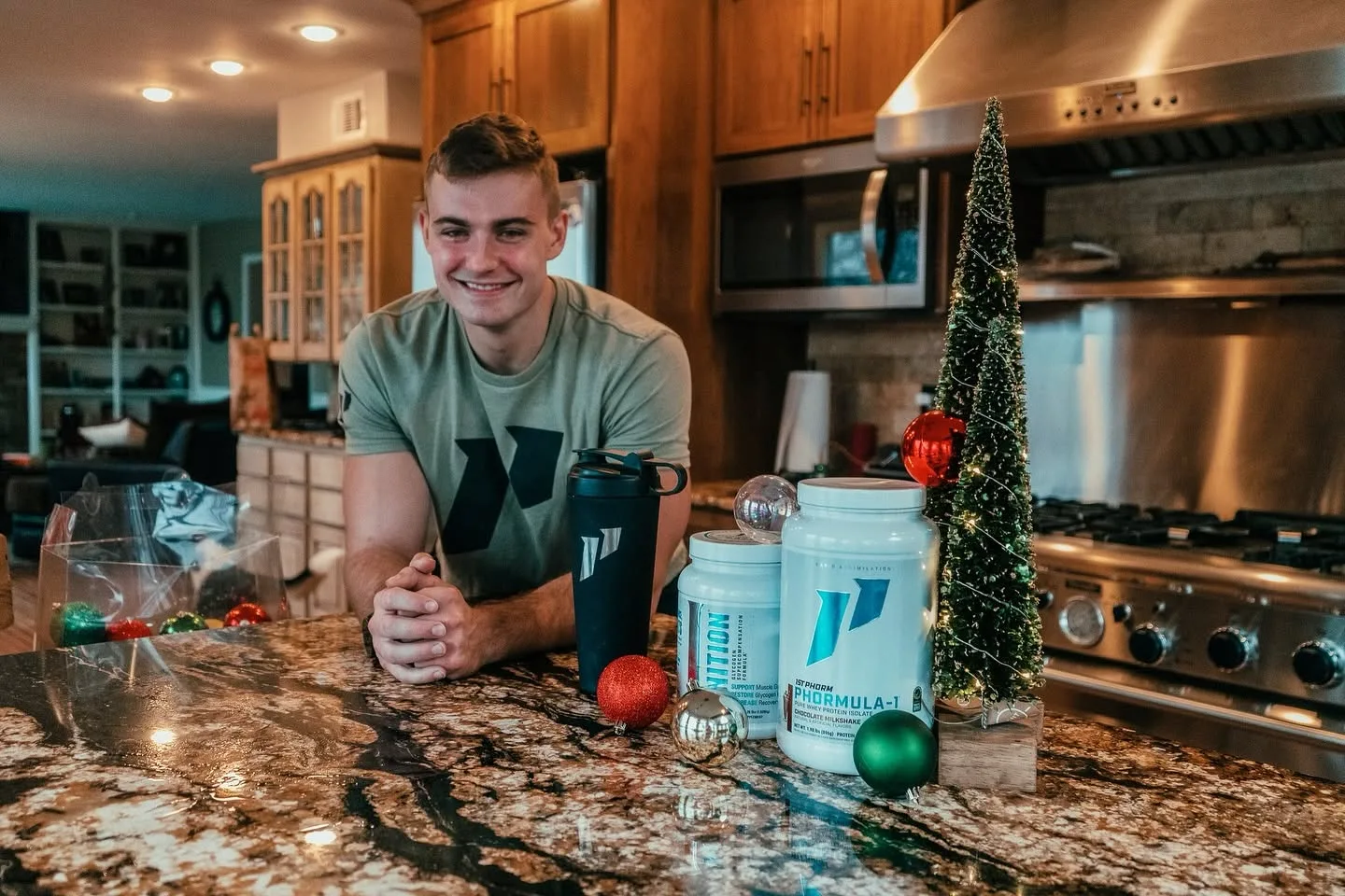 Coach Cole Greashaber smiling at a kitchen counter